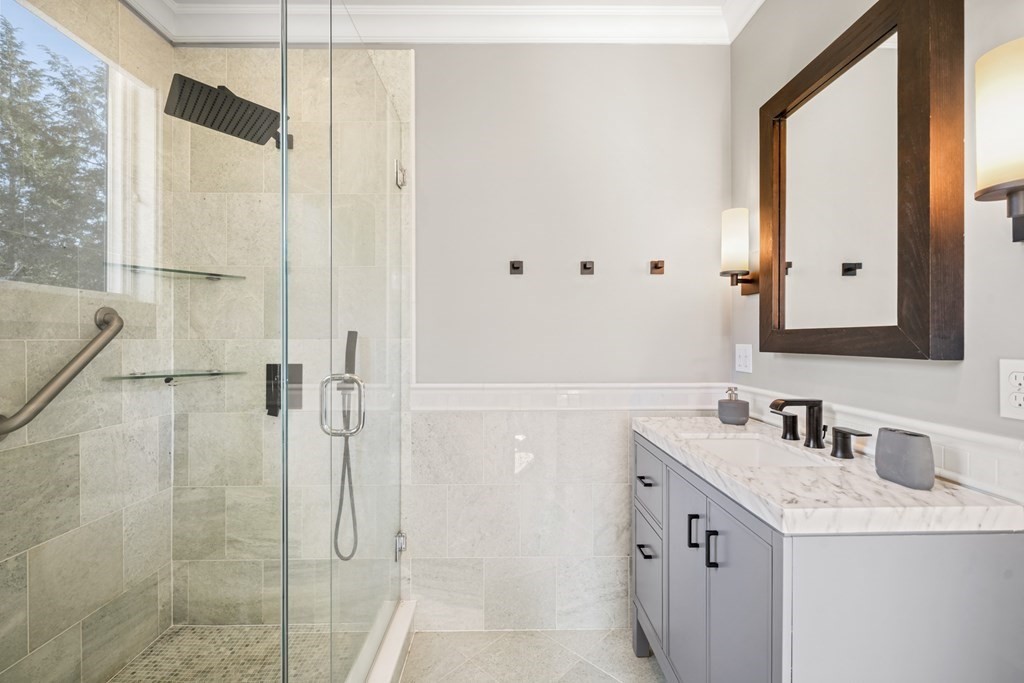 105 Eldredge Street Newton, MA 02458 - Photo 19 of 42 a bathroom with a double vanity sink mirror and shower