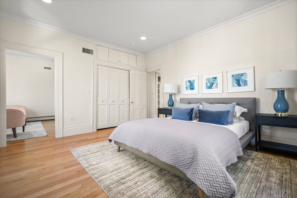 105 Eldredge Street Newton, MA 02458 - Photo 27 of 42 a spacious bedroom with a bed and a table in it