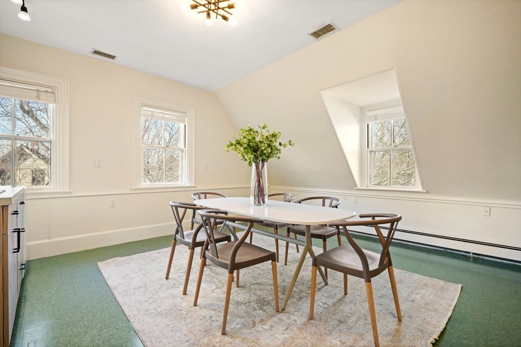 105 Eldredge Street Newton, MA 02458 - Photo 32 of 42 a view of a dining room with furniture and a potted plant