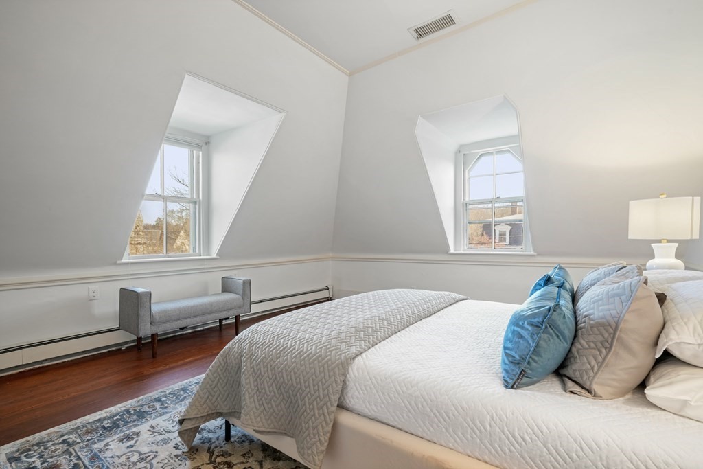 105 Eldredge Street Newton, MA 02458 - Photo 35 of 42 a bedroom with a bed and wooden floor