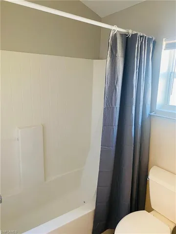 a bathroom with a shower and a toilet