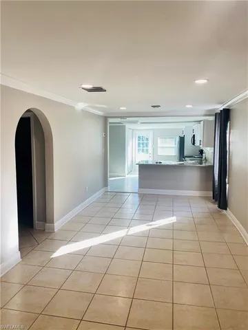 a view of a livingroom with kitchen and furniture