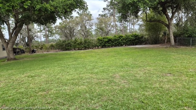 5330 Lakewood Road Sebring, FL 33875 - Photo 17 of 19 a view of a field with trees in front of it