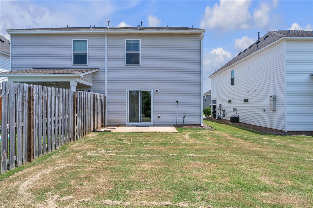 208 Samuel Street Pendleton, SC 29670 - Photo 25 of 32 A fenced backyard offers privacy and space for outdoor activities, complementing the home's contemporary design.