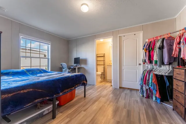 a bed room with a bed and a window