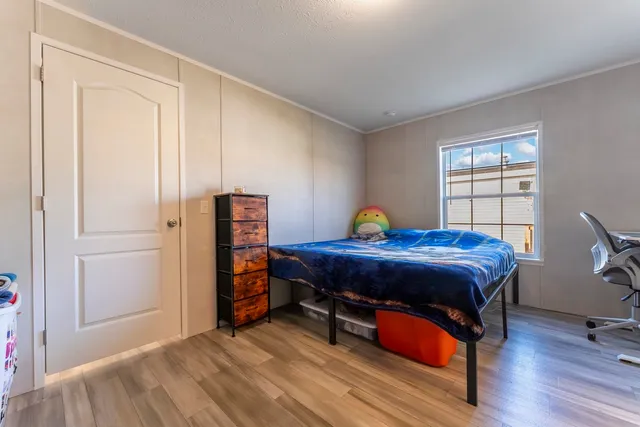 a bed sitting in a bedroom next to a window