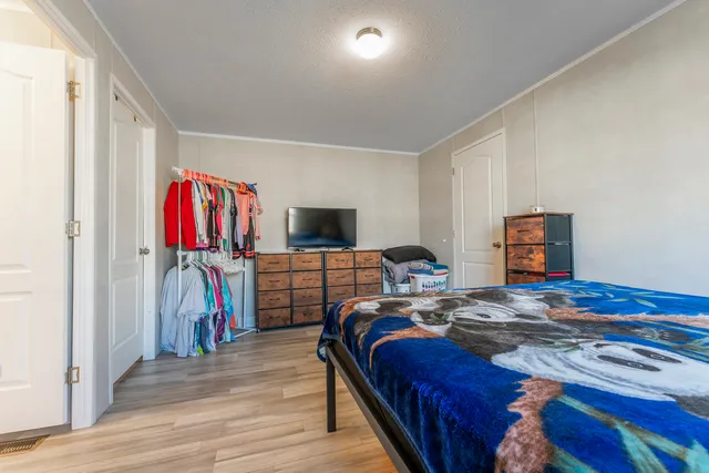 a bedroom with a bed and a flat screen tv