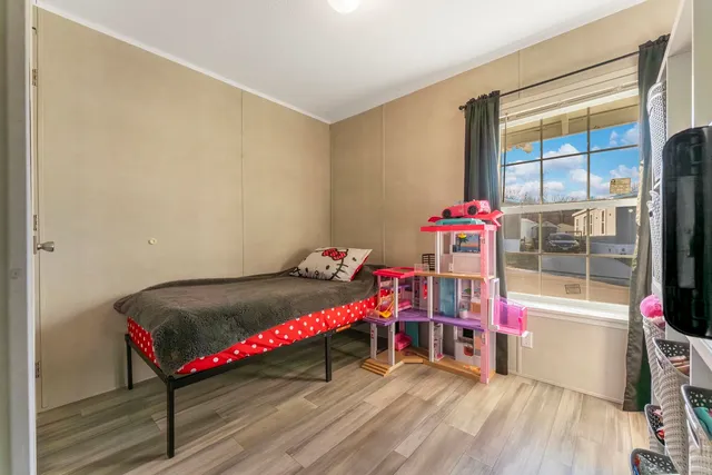 a bedroom with furniture and a wooden floor