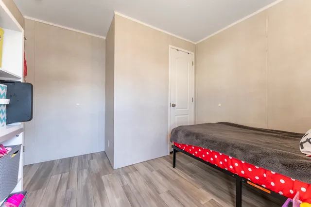a view of a room with wooden floor and closet
