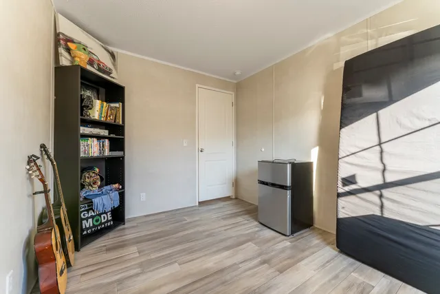 a view of a living room with furniture and a flat screen tv