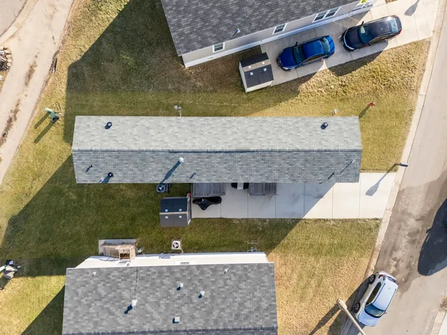 an aerial view of a house with a yard