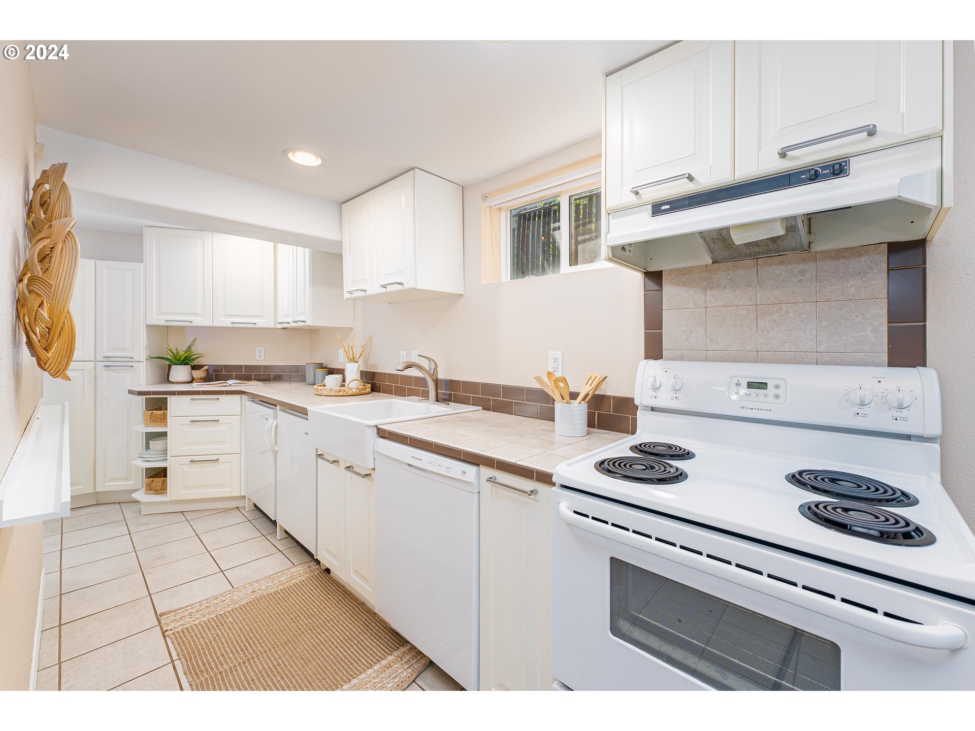 2034 Northwest Overton Street, Unit E Portland, OR 97209 - Photo 11 of 25 a white kitchen with a stove top oven a sink and cabinets