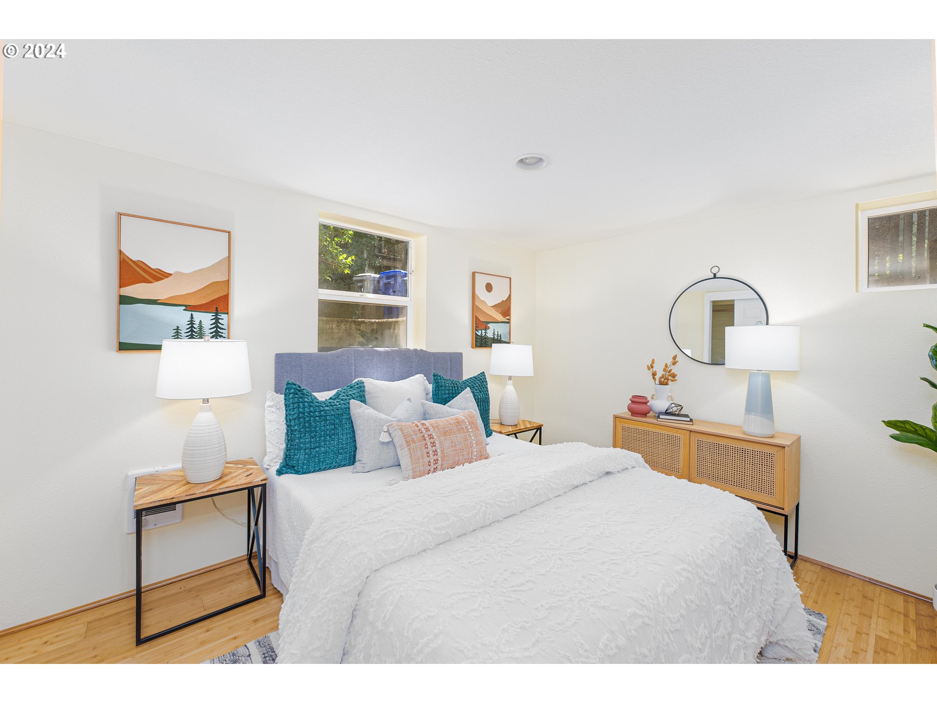2034 Northwest Overton Street, Unit E Portland, OR 97209 - Photo 12 of 25 a bedroom with a bed and a painting on the wall