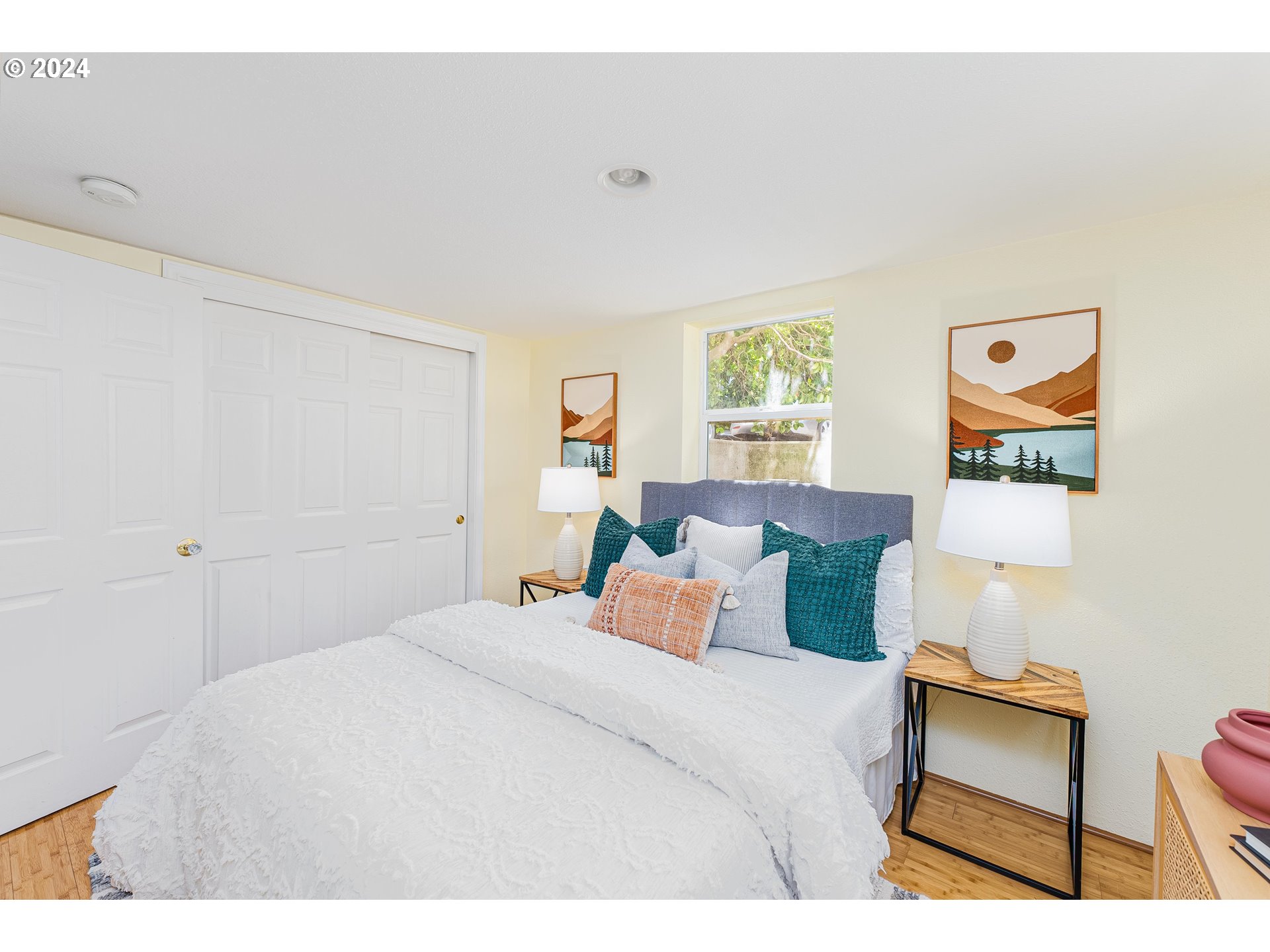 2034 Northwest Overton Street, Unit E Portland, OR 97209 - Photo 13 of 25 a bedroom with a bed and a painting on the wall