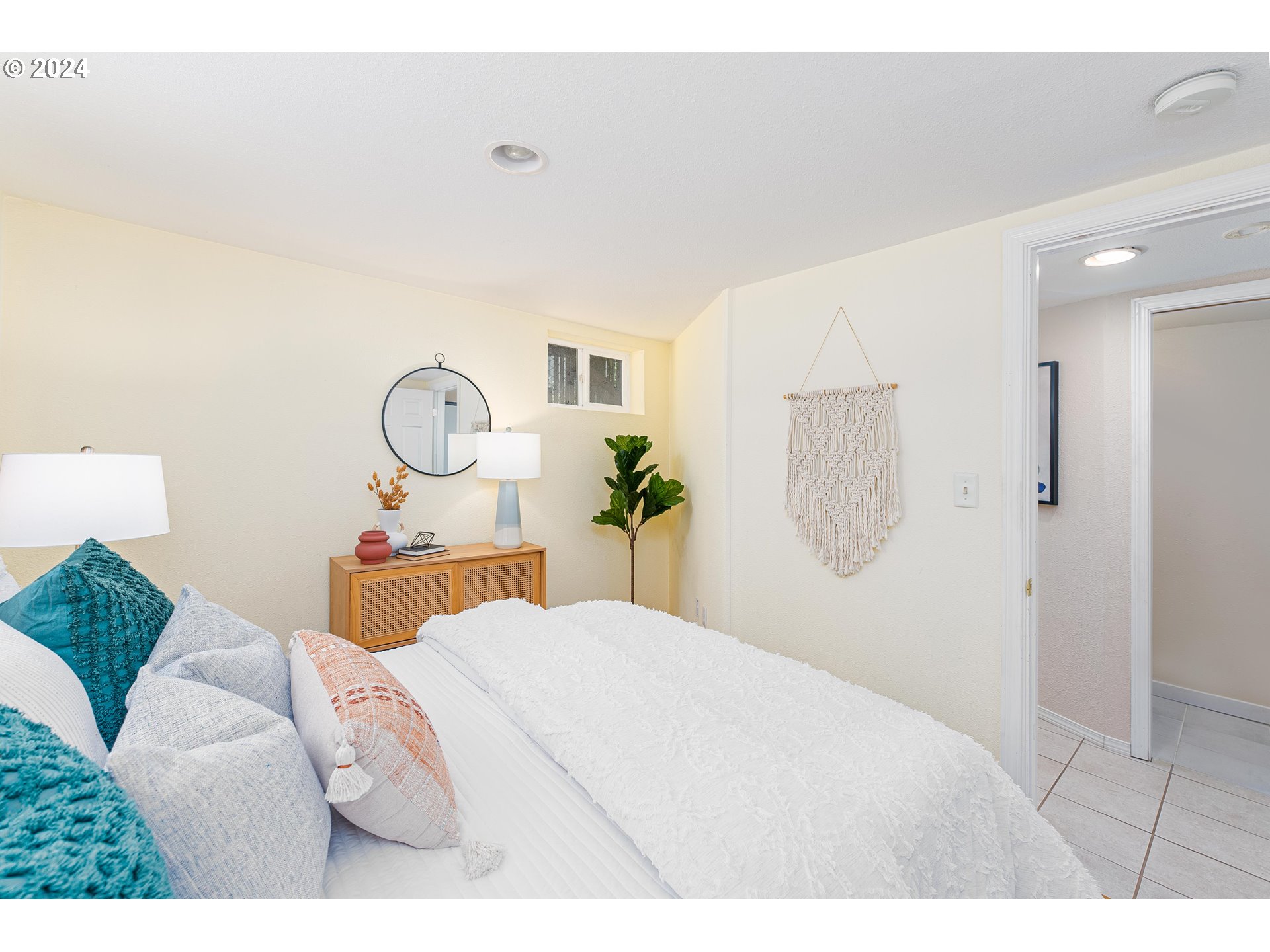 2034 Northwest Overton Street, Unit E Portland, OR 97209 - Photo 14 of 25 a bedroom with a large bed and a chandelier