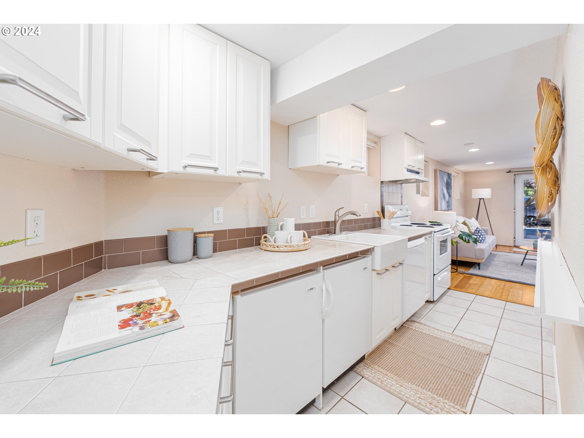 2034 Northwest Overton Street, Unit E Portland, OR 97209 - Photo 10 of 25 a kitchen with stainless steel appliances kitchen island wooden cabinets and sink