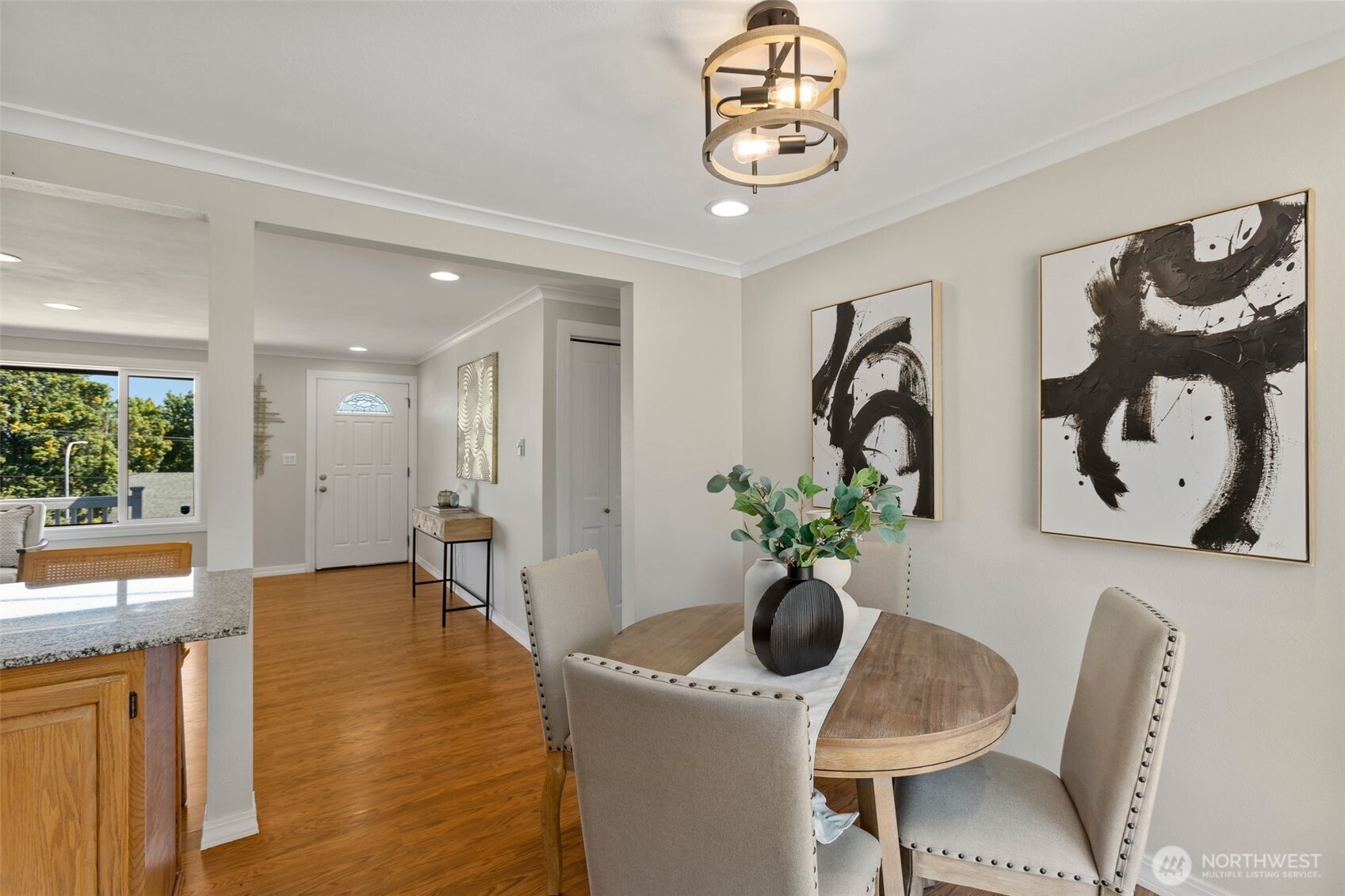 216 Bridgeway Everett, WA 98201 - Photo 15 of 40 a dining room with furniture potted plants and wooden floor