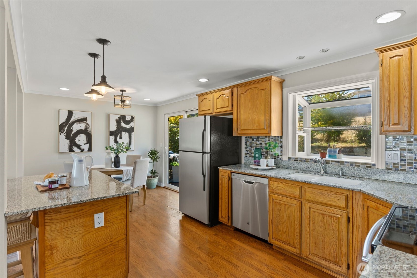 216 Bridgeway Everett, WA 98201 - Photo 18 of 40 a kitchen with sink refrigerator and microwave