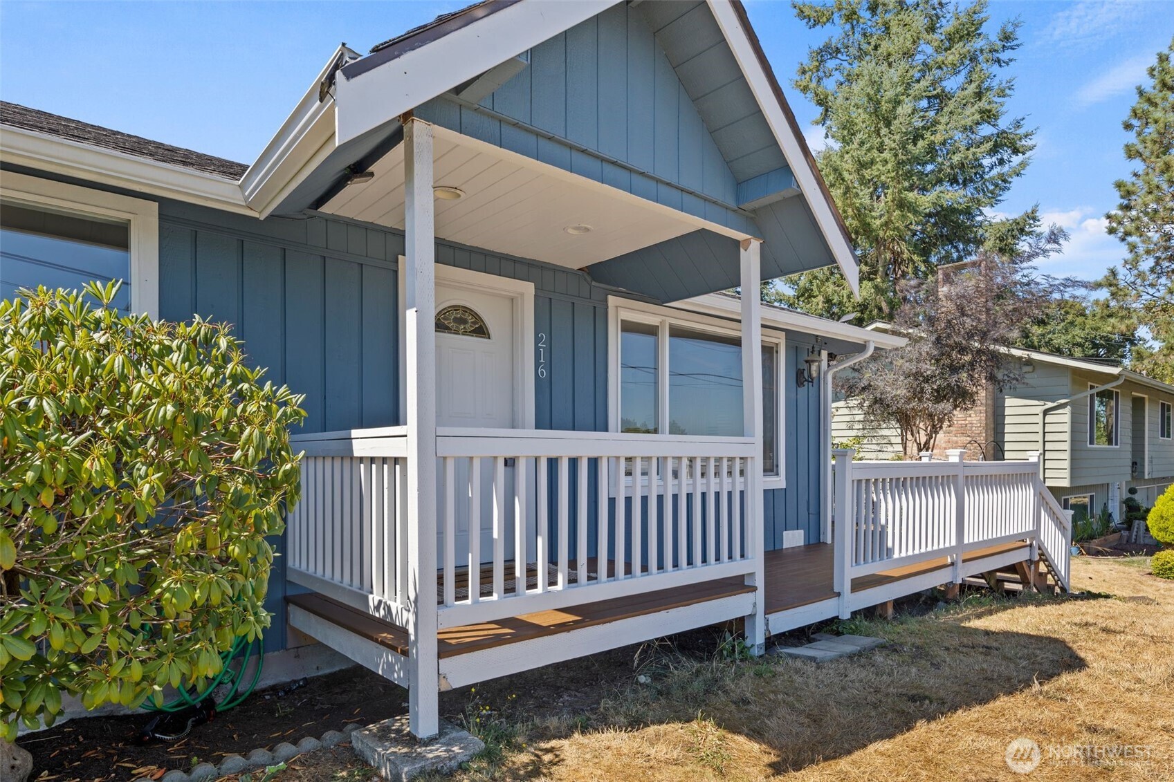 216 Bridgeway Everett, WA 98201 - Photo 4 of 40 a view of a house with a yard and wooden fence