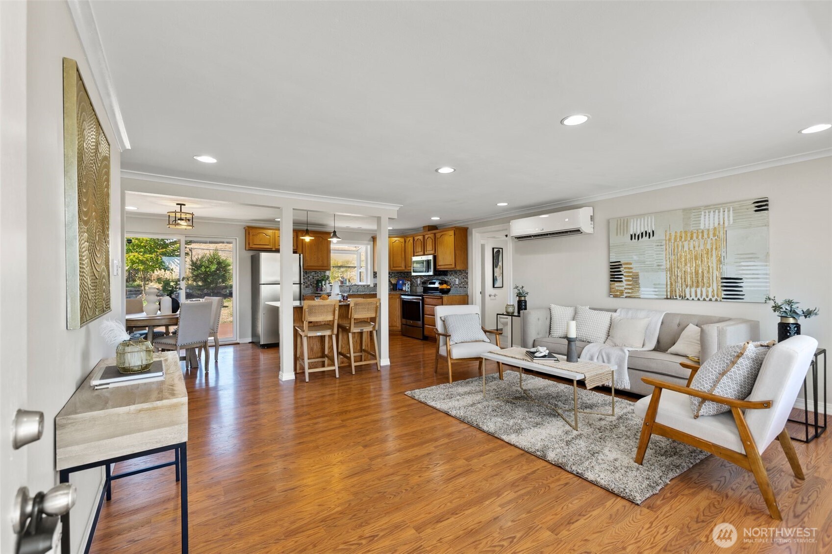 216 Bridgeway Everett, WA 98201 - Photo 6 of 40 a living room with lots of furniture wooden floor and a large window