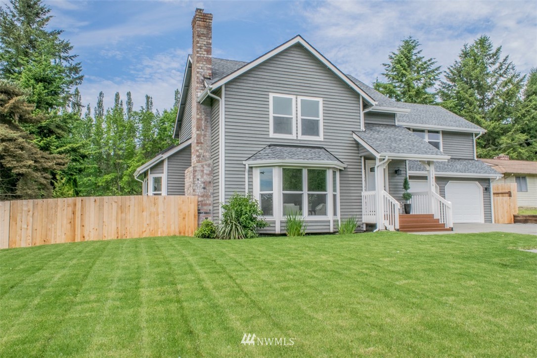 17916 Tester Road Snohomish, WA 98290 - Photo 2 of 28 a view of a yard in front of a house with plants and large tree