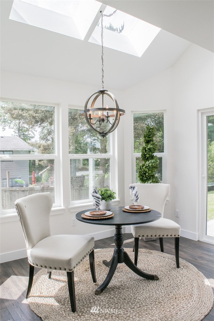 17916 Tester Road Snohomish, WA 98290 - Photo 11 of 28 a living room with a table and a floor to ceiling window