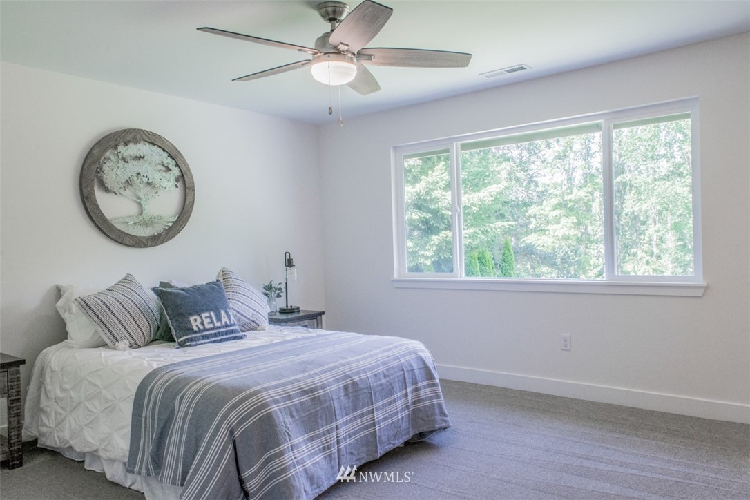 17916 Tester Road Snohomish, WA 98290 - Photo 18 of 28 a bedroom with a large bed and a window