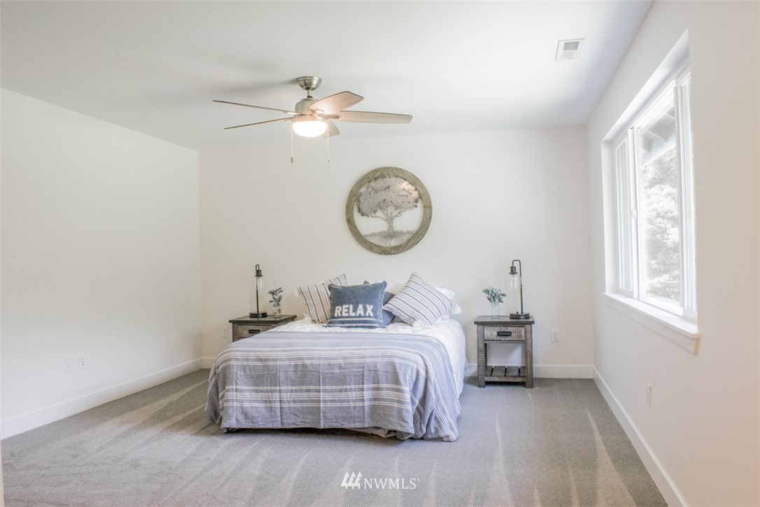 17916 Tester Road Snohomish, WA 98290 - Photo 19 of 28 a bedroom with bed and a clock on the wall