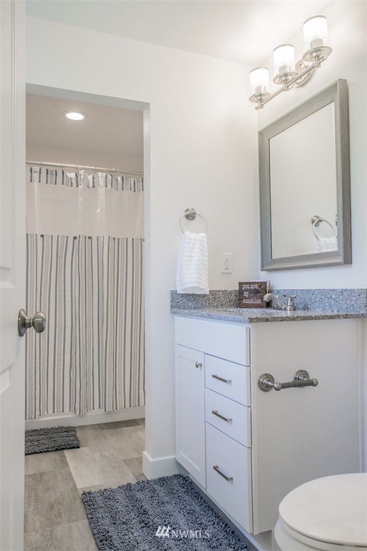 17916 Tester Road Snohomish, WA 98290 - Photo 20 of 28 a bathroom with a granite countertop sink vanity mirror and toilet