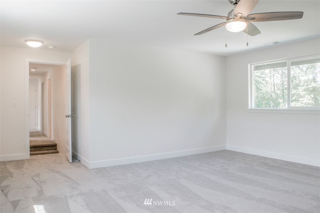 17916 Tester Road Snohomish, WA 98290 - Photo 21 of 28 an empty room with a ceiling fan and a window