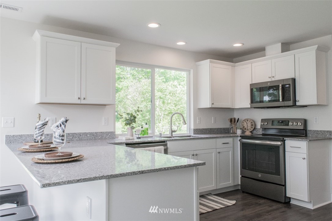 17916 Tester Road Snohomish, WA 98290 - Photo 6 of 28 a kitchen with sink a microwave and cabinets