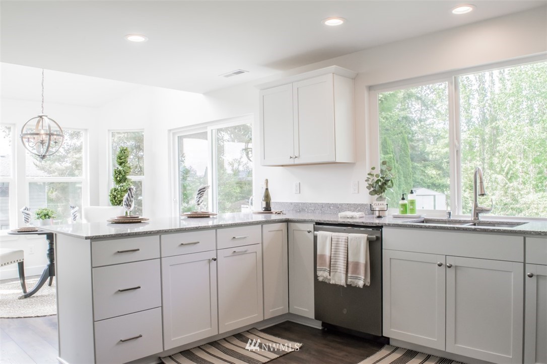 17916 Tester Road Snohomish, WA 98290 - Photo 7 of 28 a kitchen with a sink window and cabinets