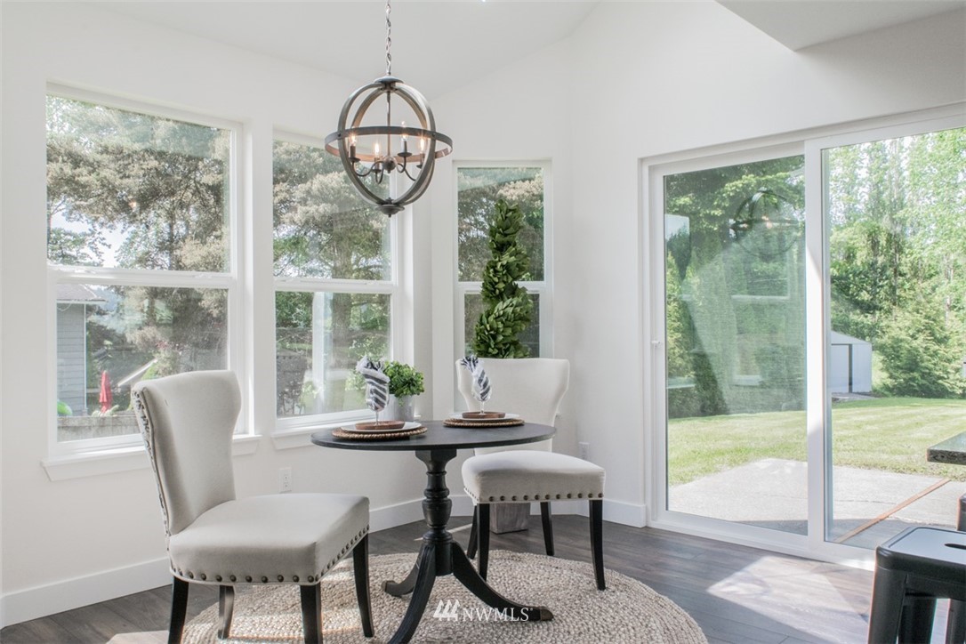 17916 Tester Road Snohomish, WA 98290 - Photo 10 of 28 a dining room with furniture a chandelier and wooden floor