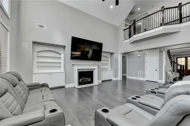 a large white kitchen with lots of counter space a sink appliances and cabinets
