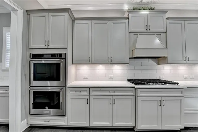 a view of an empty room with wooden floor fireplace and a window