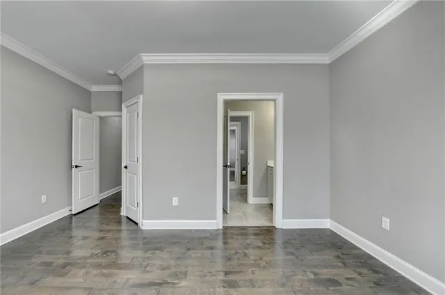 an empty room with windows and cabinet