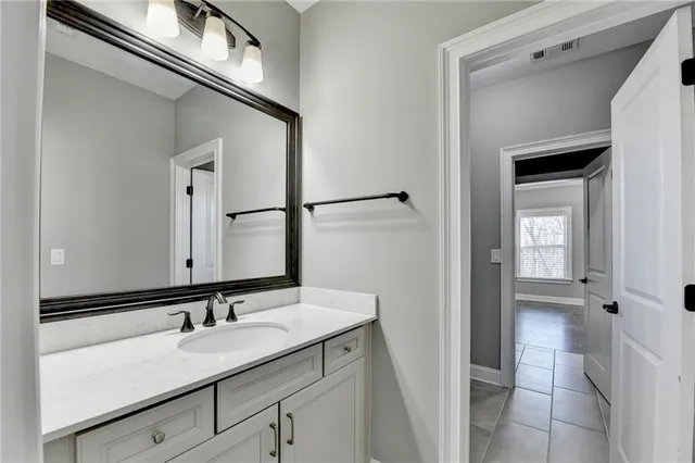 a view of a hallway that has a table and chair