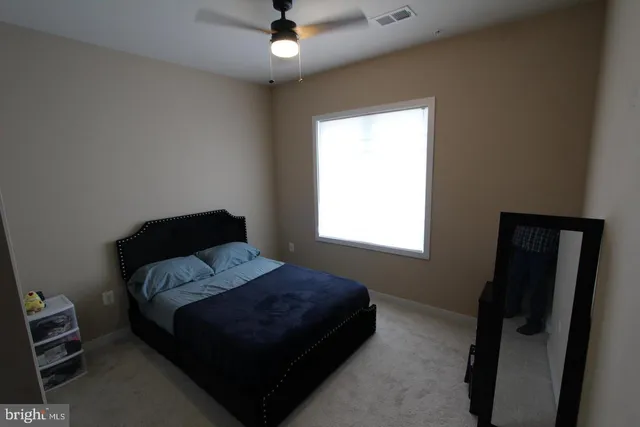 a bedroom with a bed and a window