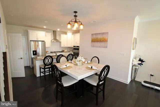 a view of a a dining room with furniture and wooden floor