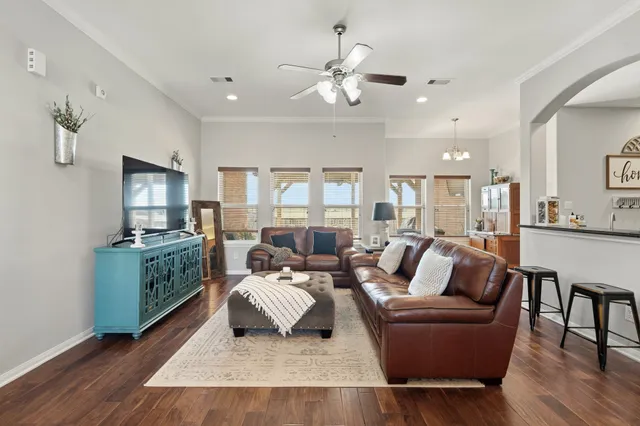 a living room with furniture and a wooden floor