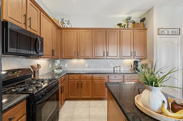 a kitchen with stainless steel appliances a stove a sink and a microwave
