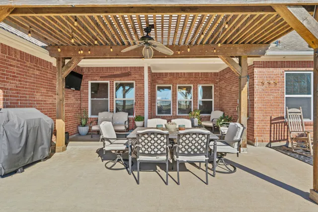 a view of a patio with table and chairs