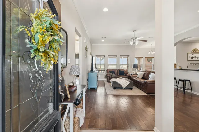 a living room with furniture and a chandelier