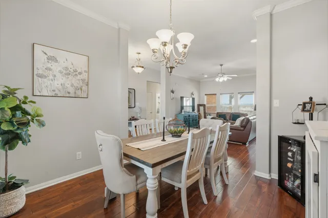 a view of a dining room with furniture wooden floor and a chandelier