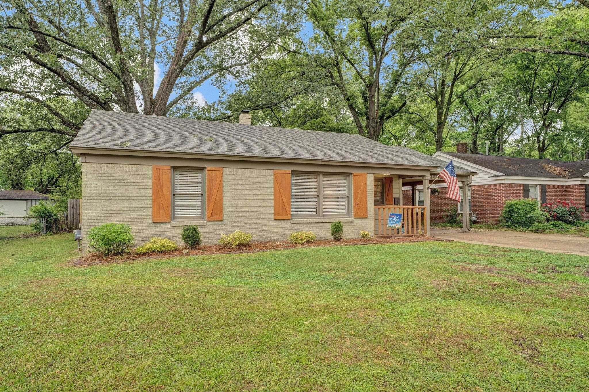 1459 Colonial Road Memphis, TN 38117 - Photo 1 of 33 a front view of a house with a garden