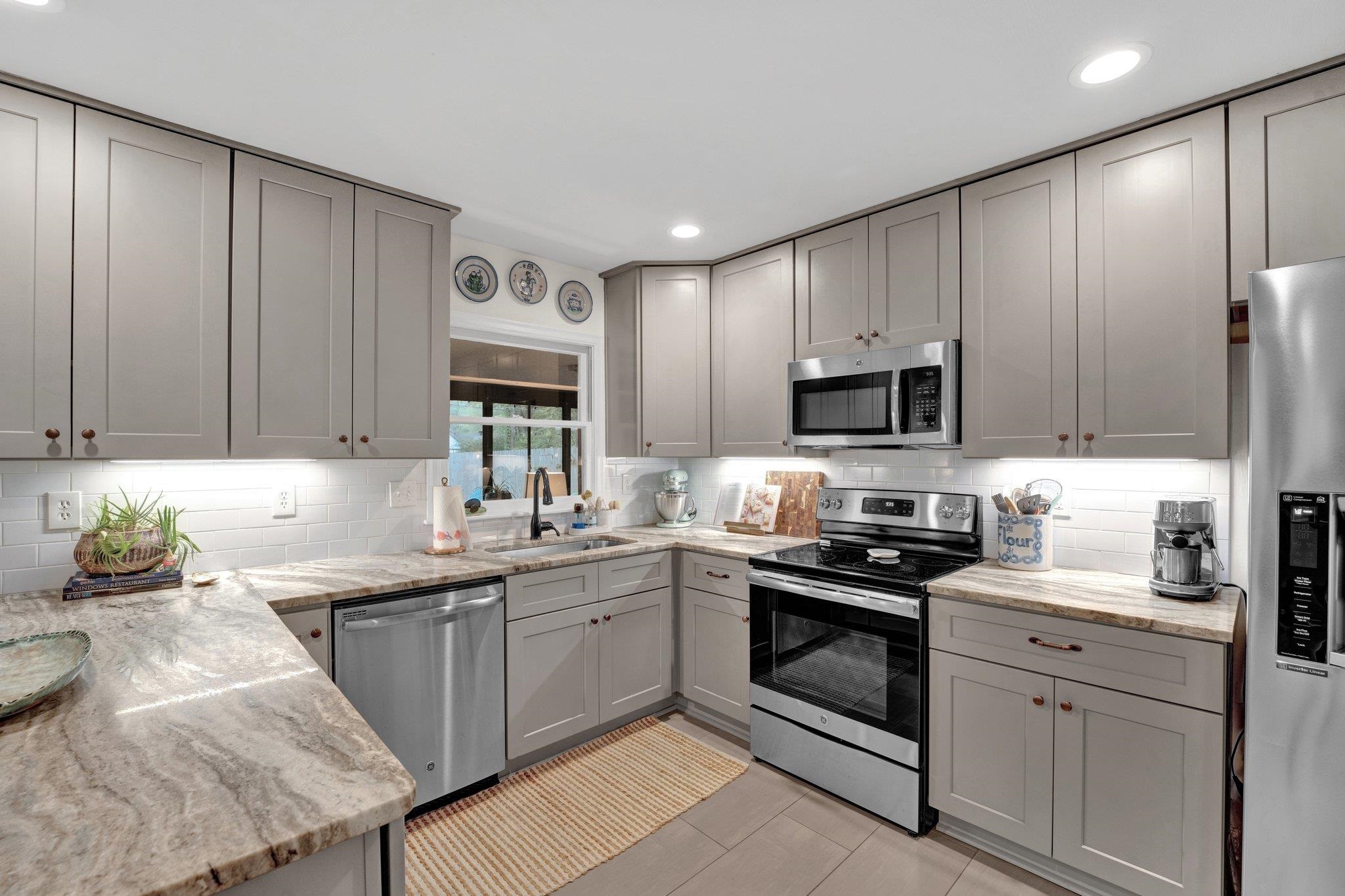 1459 Colonial Road Memphis, TN 38117 - Photo 11 of 33 a kitchen with a sink a stove and cabinets