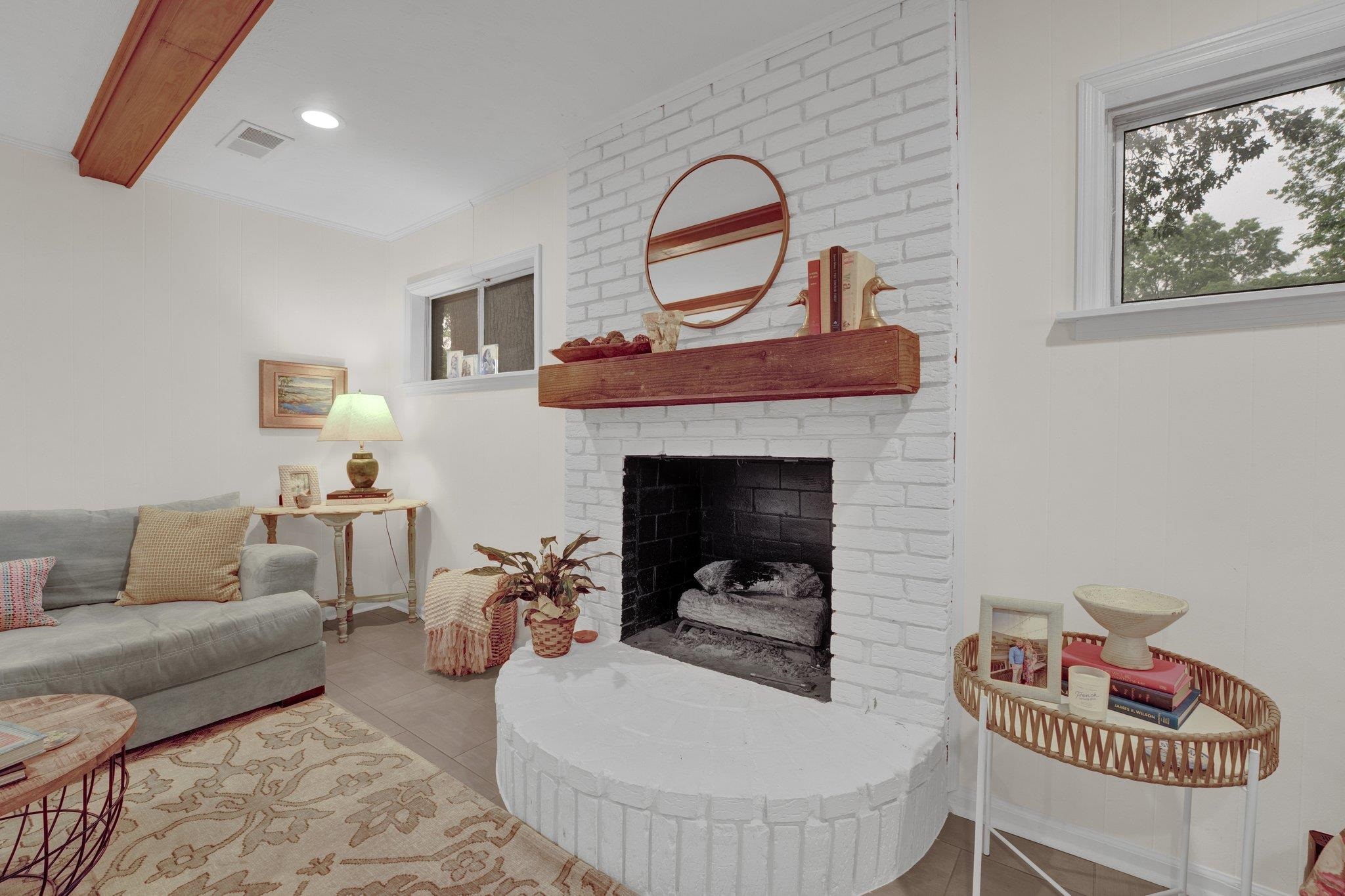 1459 Colonial Road Memphis, TN 38117 - Photo 18 of 33 a living room with furniture a rug and a fireplace