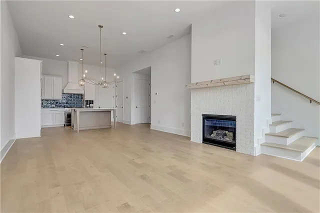 a view of a kitchen with a sink and a fireplace