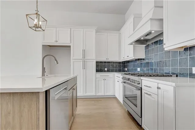 a kitchen with white cabinets and white appliances