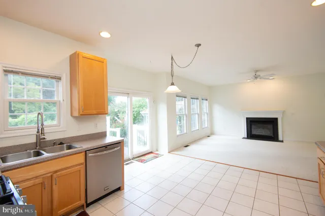 a kitchen with granite countertop a sink and a stove